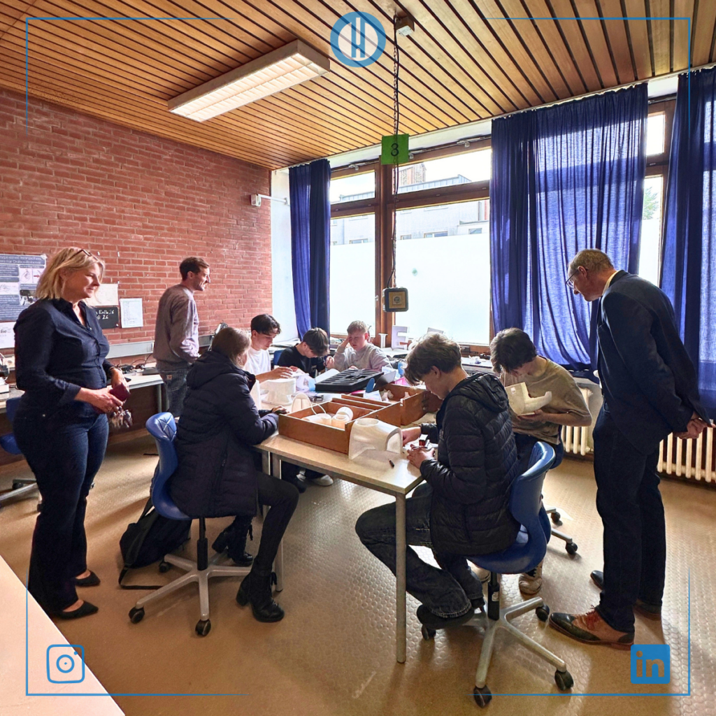 Students engaged in hands-on learning activity, collaborating in a classroom setting under natural light.