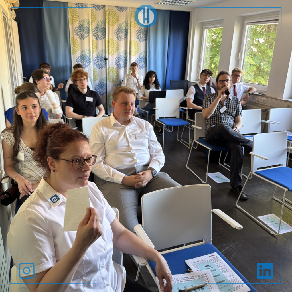 Participants engaged in a workshop, listening attentively in a brightly lit room with colorful decor.