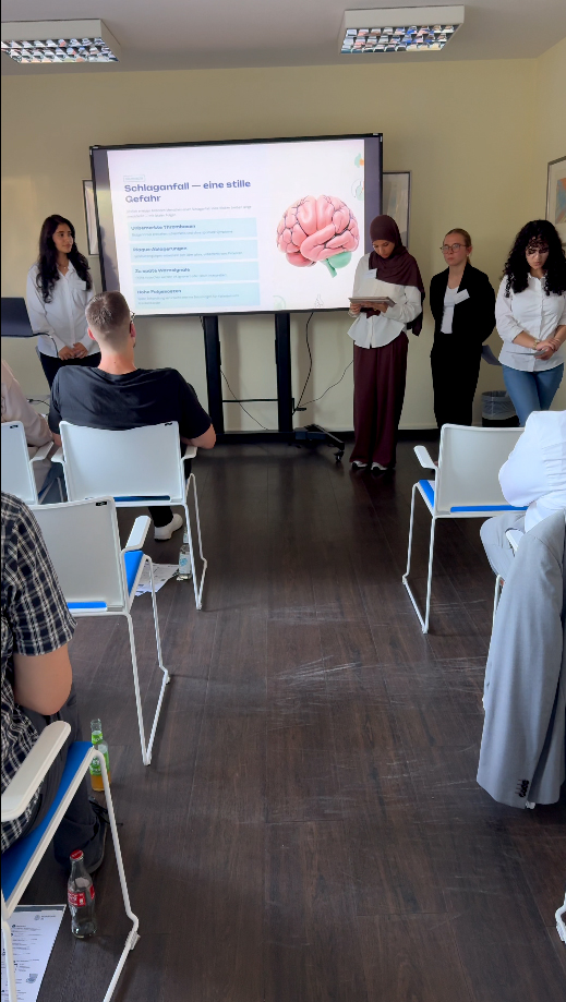 Participants presenting innovative AI-powered nano-devices for stroke prevention at the MIG event.