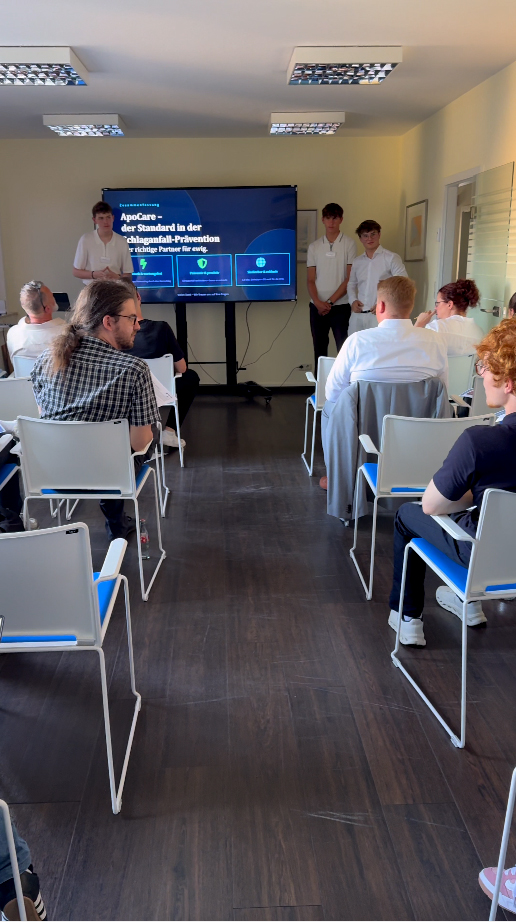 Participants presenting innovative AI-powered nano-devices for stroke prevention at the MIG event.