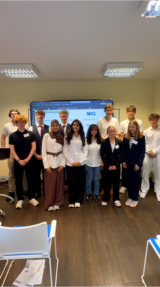 Participants presenting innovative AI-powered nano-devices for stroke prevention at the MIG event.